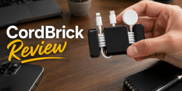 CordBrick weighted cord holder organizing cables on a wooden desk